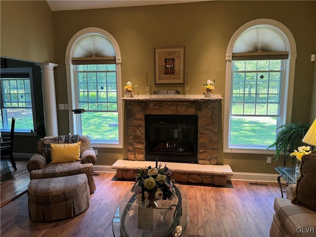 living room featuring hardwood / wood-style flooring and a stone fireplace