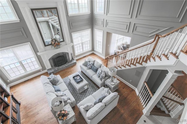 living room featuring a towering ceiling and hardwood / wood-style floors