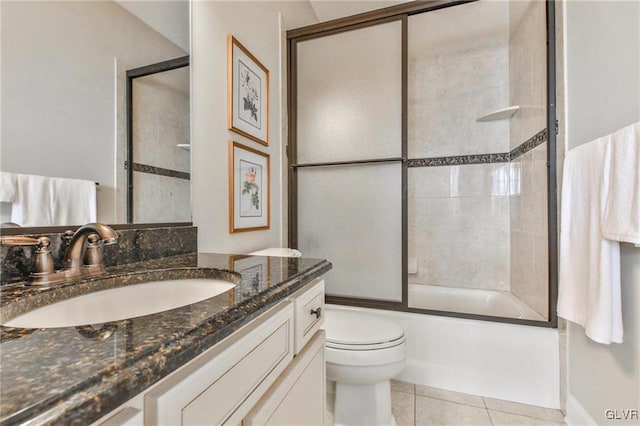 full bathroom featuring tile patterned flooring, enclosed tub / shower combo, toilet, and vanity