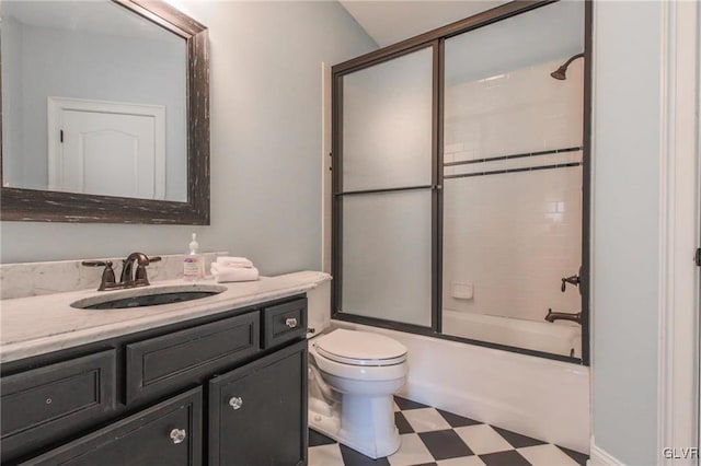 full bathroom featuring enclosed tub / shower combo, toilet, and vanity