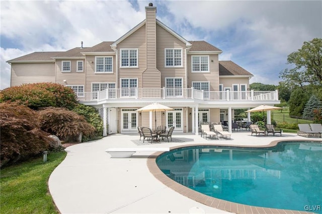 back of property featuring a patio area and a balcony