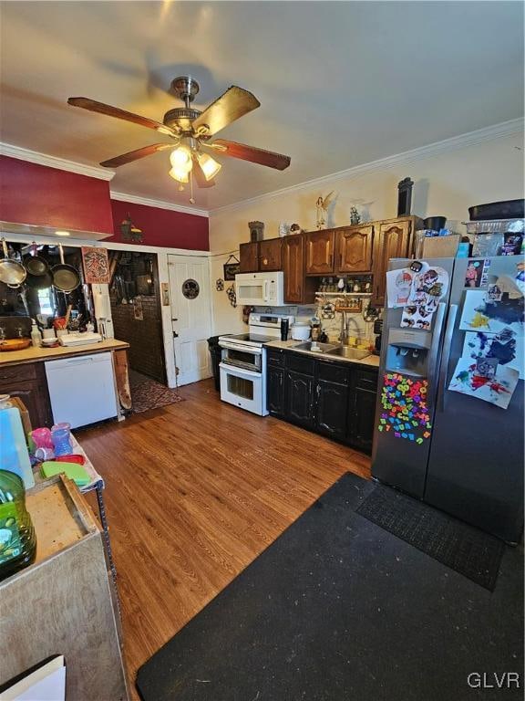 kitchen featuring white appliances, sink, wood-type flooring, ceiling fan, and ornamental molding