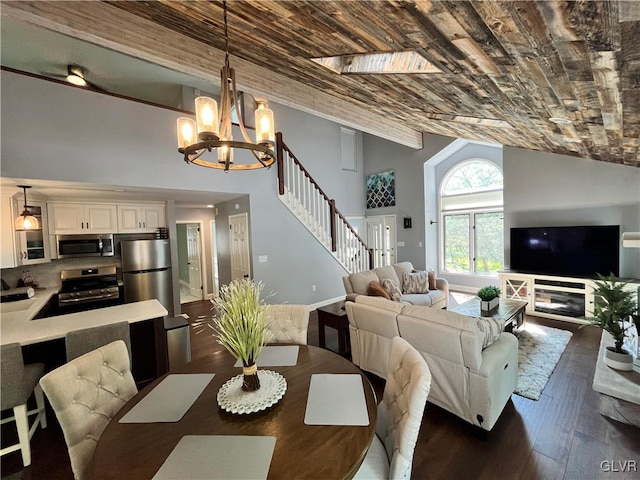 dining space featuring dark hardwood / wood-style flooring, high vaulted ceiling, and a notable chandelier