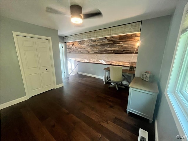 home office with ceiling fan and dark wood-type flooring