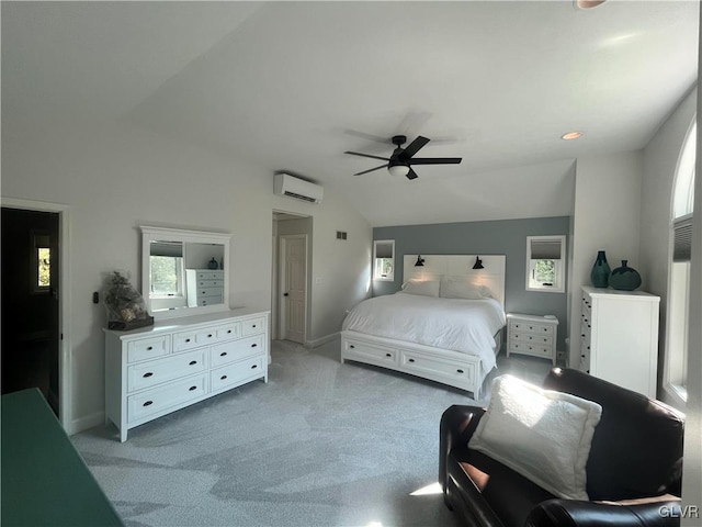 bedroom with ceiling fan, light colored carpet, vaulted ceiling, and a wall unit AC