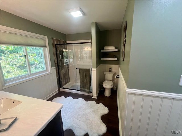 bathroom featuring walk in shower, vanity, toilet, and hardwood / wood-style flooring