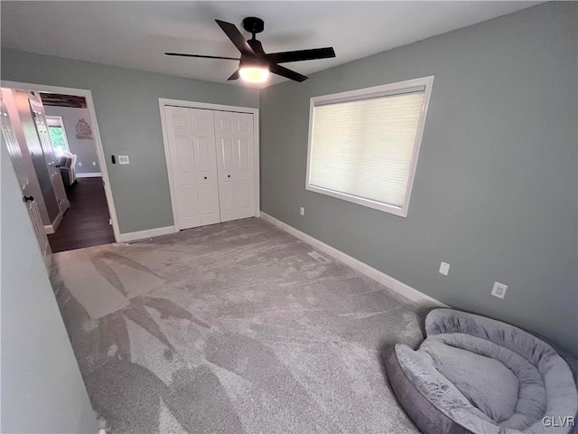 bedroom with a closet, ceiling fan, and carpet floors