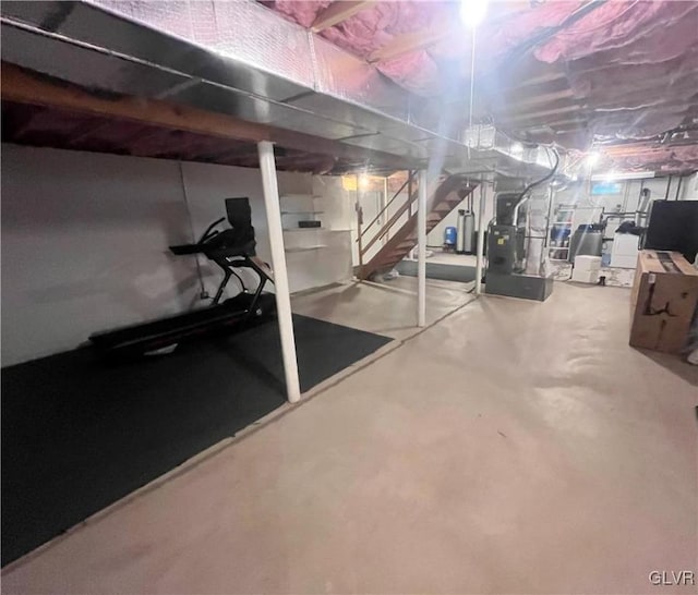 basement featuring water heater and heating unit