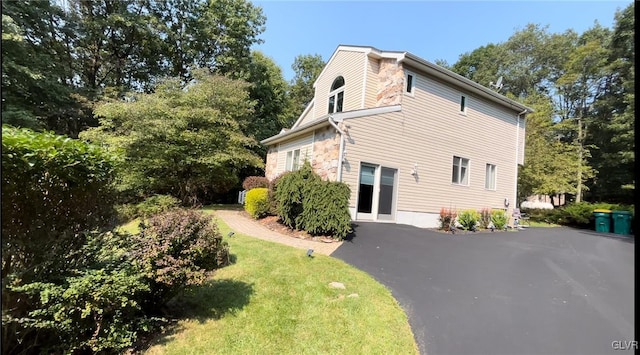 view of property exterior featuring a lawn