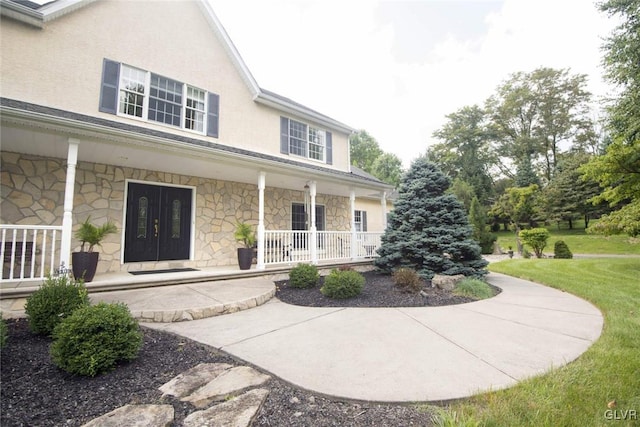 exterior space featuring a yard and covered porch