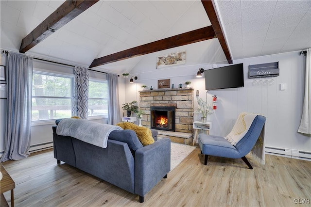 living room featuring hardwood / wood-style flooring, baseboard heating, lofted ceiling with beams, and a stone fireplace