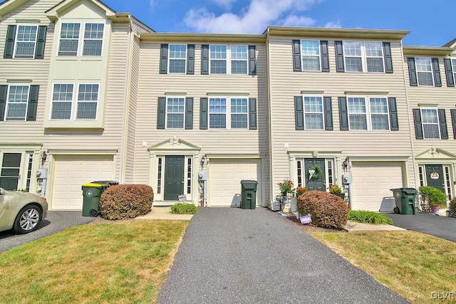 view of property with a front yard and a garage