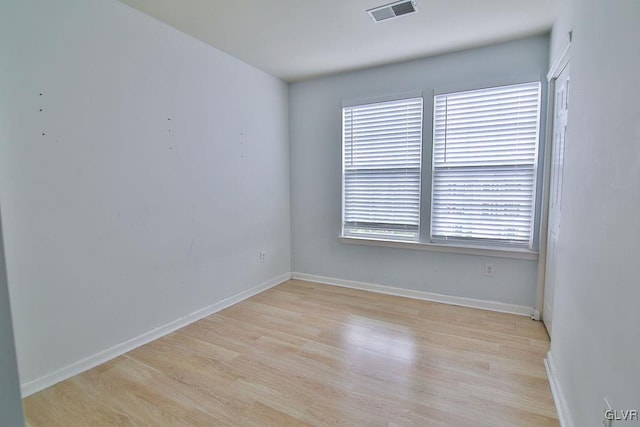 spare room featuring light hardwood / wood-style flooring