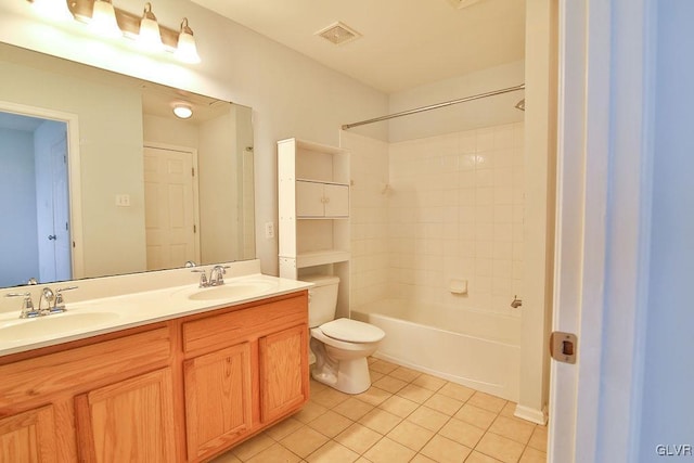 full bathroom featuring tiled shower / bath combo, vanity, tile patterned flooring, and toilet