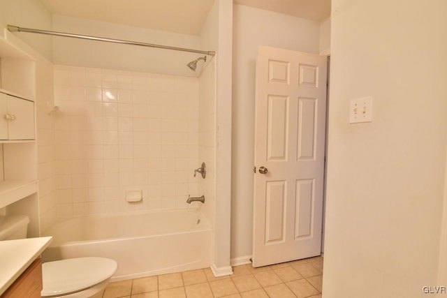 full bathroom with tiled shower / bath, vanity, toilet, and tile patterned floors