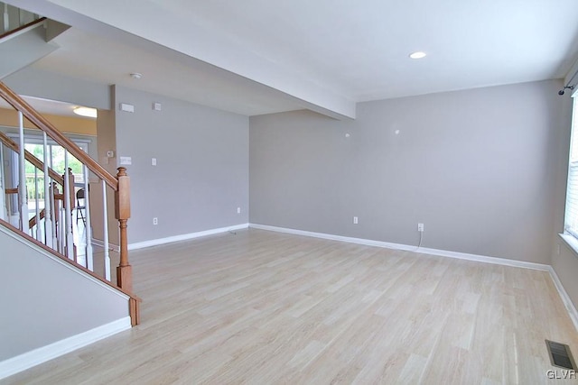 empty room with light hardwood / wood-style flooring