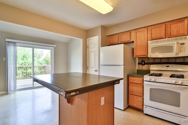 kitchen with white appliances and a kitchen bar