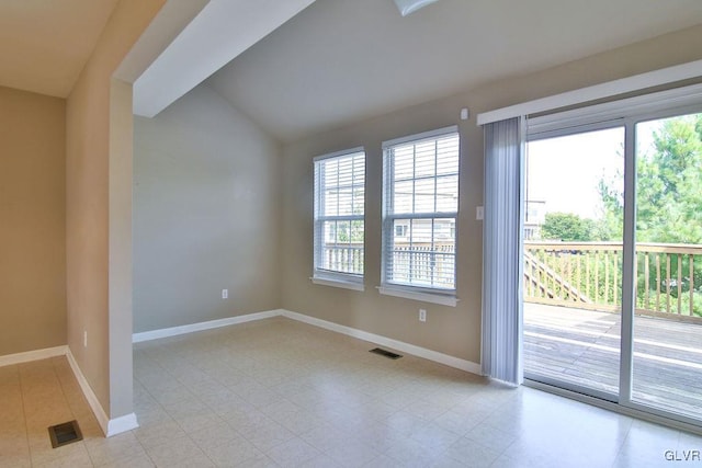 unfurnished room featuring lofted ceiling