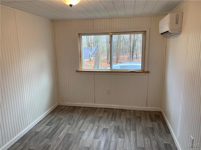 spare room with wood walls, wood-type flooring, and an AC wall unit