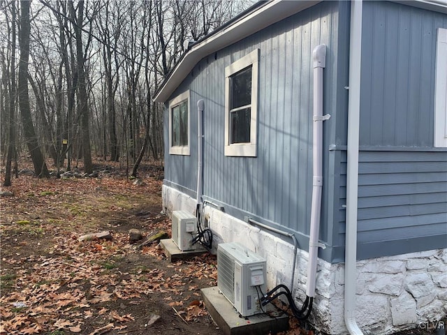 view of side of home featuring ac unit