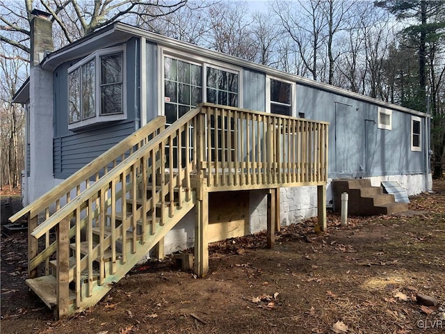 back of house with a wooden deck