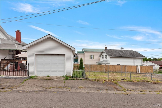 view of front facade featuring a garage and an outbuilding