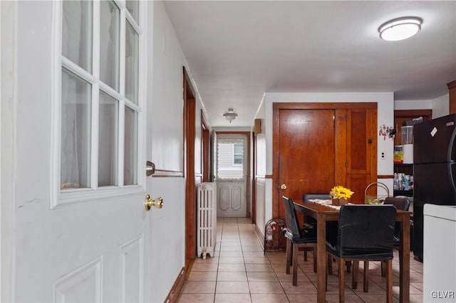 tiled dining room featuring radiator heating unit