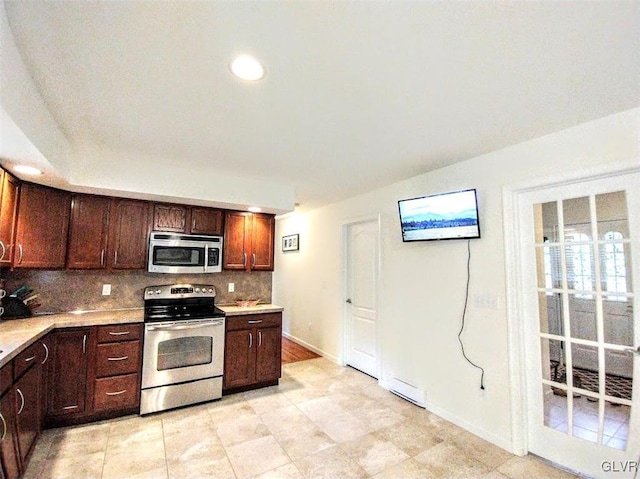 kitchen featuring appliances with stainless steel finishes, light tile patterned flooring, and tasteful backsplash