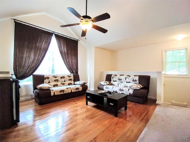 living room featuring hardwood / wood-style floors, vaulted ceiling, and ceiling fan