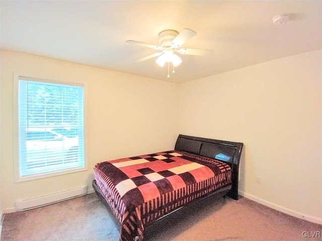 bedroom featuring baseboard heating, light colored carpet, and ceiling fan