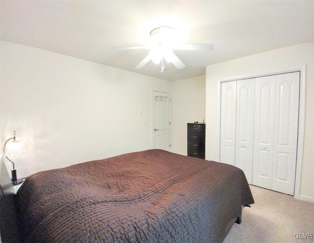 bedroom with light carpet, a closet, and ceiling fan