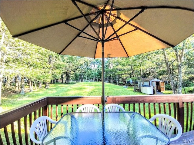 wooden deck with a yard and a shed