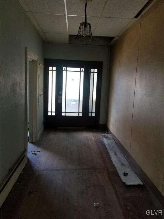 entrance foyer featuring hardwood / wood-style flooring and a drop ceiling