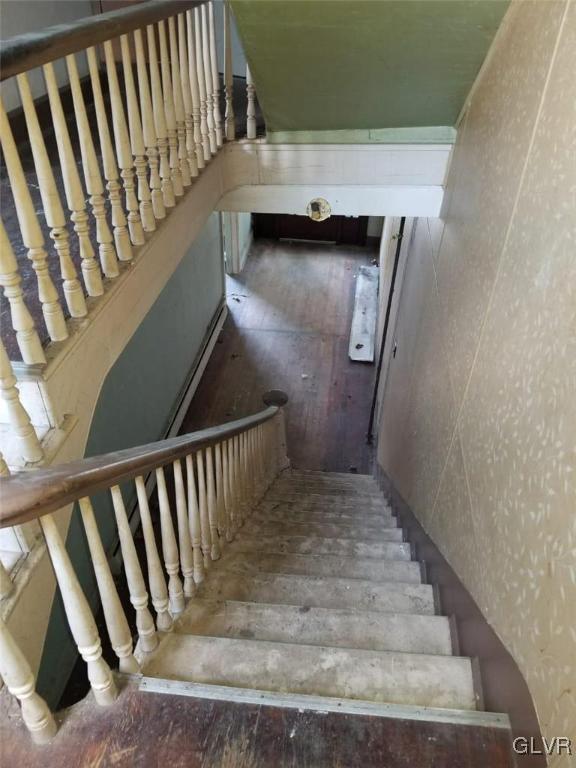 staircase featuring hardwood / wood-style flooring