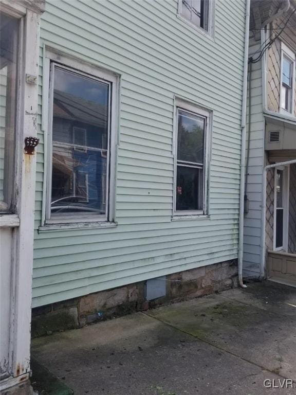 view of side of home with a patio area