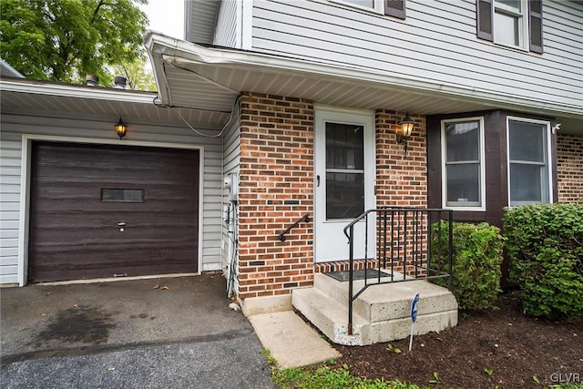 doorway to property with a garage