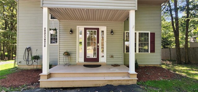 view of exterior entry with covered porch