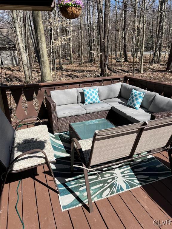 wooden balcony featuring outdoor lounge area and a wooden deck