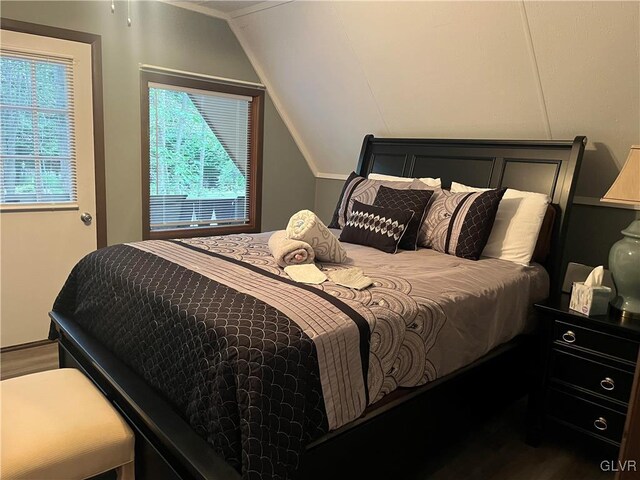 bedroom featuring vaulted ceiling and hardwood / wood-style flooring