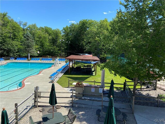 view of pool featuring a yard and a patio