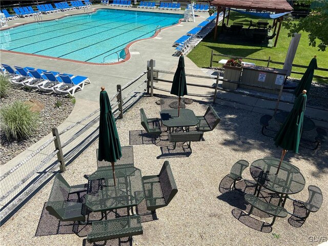 view of swimming pool with a lawn and a patio