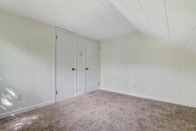 additional living space featuring carpet and lofted ceiling