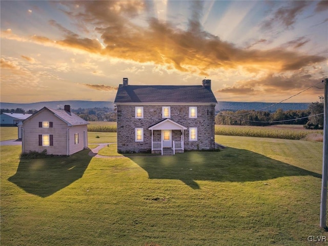 colonial home featuring a yard