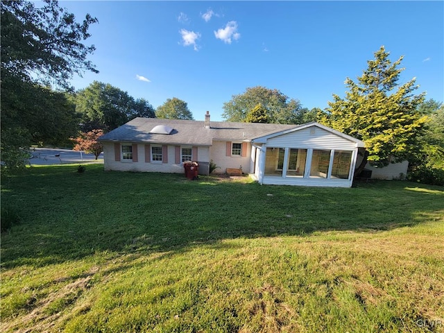 back of house with a lawn