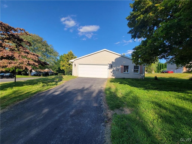 ranch-style home featuring a front lawn and a garage