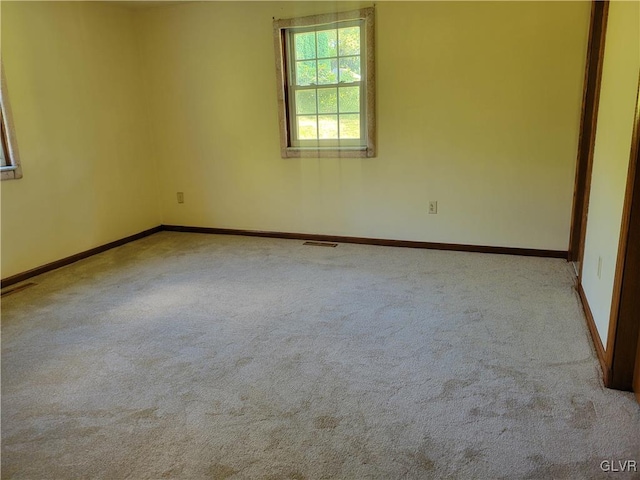 unfurnished room featuring light colored carpet