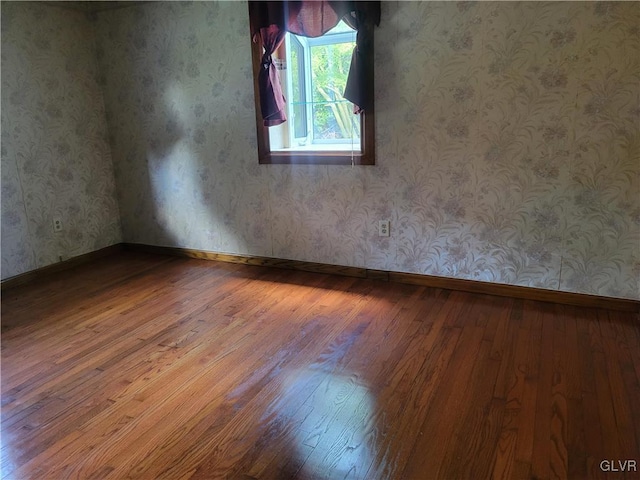 unfurnished room with hardwood / wood-style floors