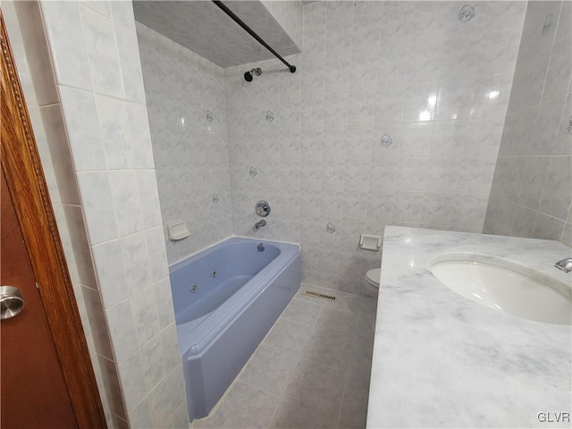 full bathroom with tile walls, tiled shower / bath combo, toilet, and tile patterned floors