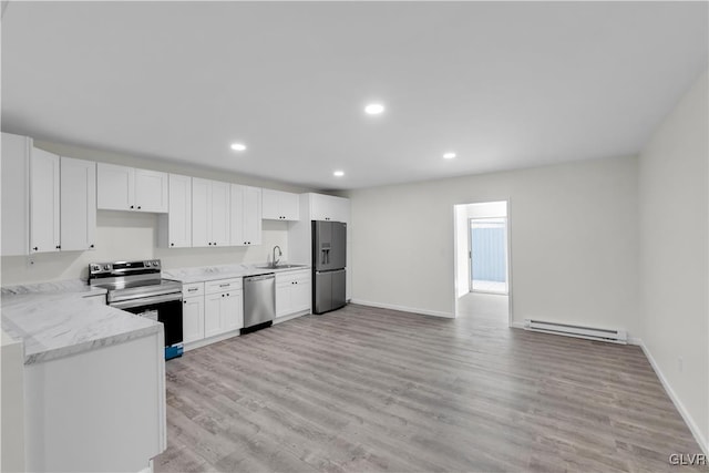 kitchen featuring a baseboard radiator, stainless steel appliances, light stone counters, and white cabinetry