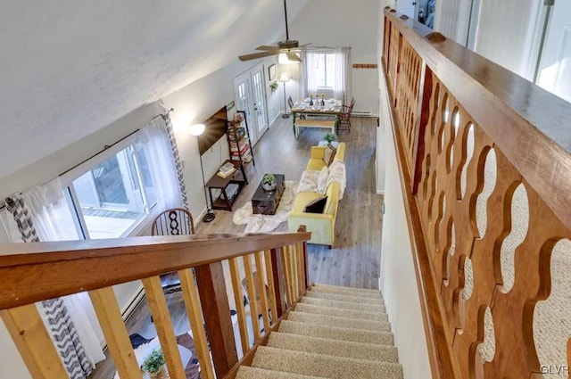 stairs with vaulted ceiling and wood finished floors